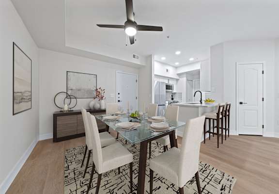 a living room and dining room with a table and chairs